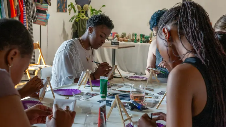 People taking part in a small hands-on workshop class